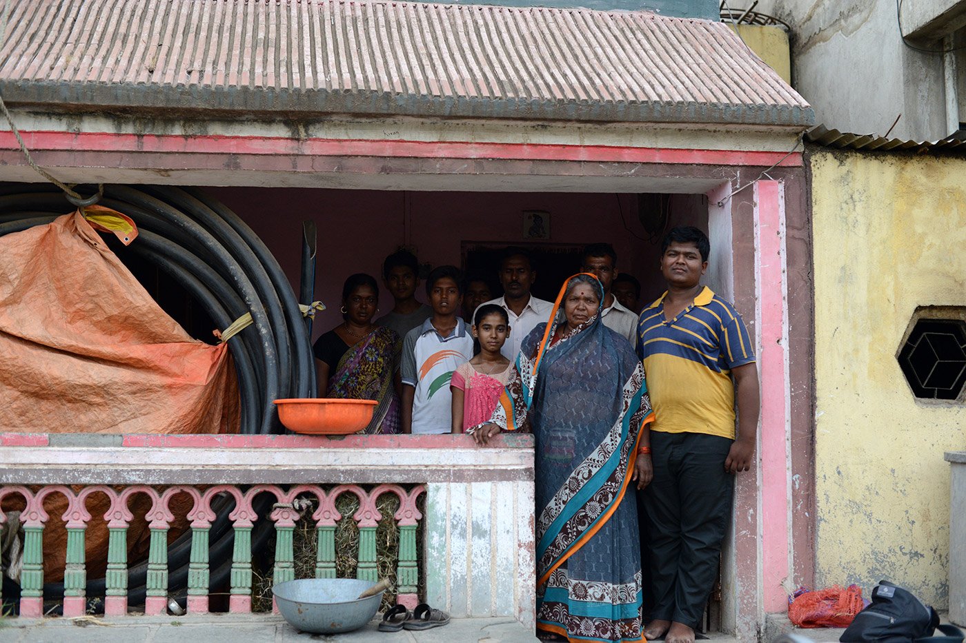 Hirabai standing on a balcony with her family