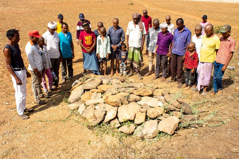 Right: Family members gathered at Anip's samadhi in the field for his funeral