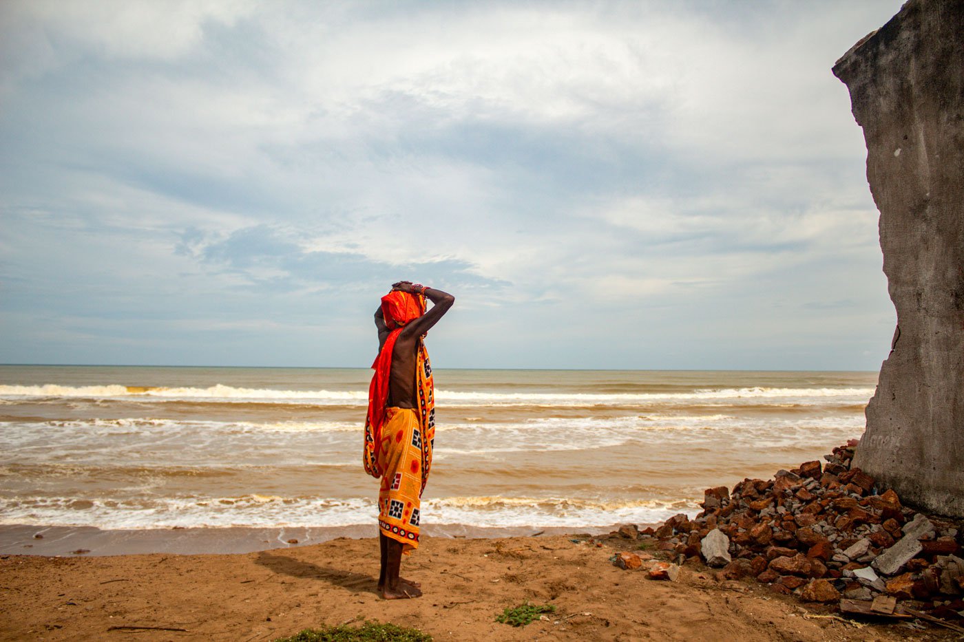 Auti looks at the remains of a home in Podampeta village