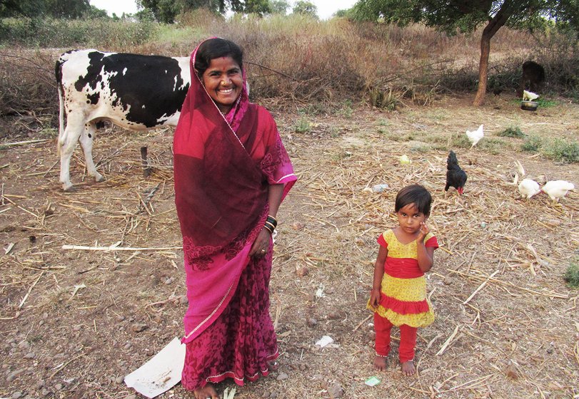 A woman in a field with a young girl