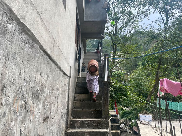 Maya Thami climbs 200 stairs to deliver the day's first gas cylinder. Like other porters, she migrated from Nepal to work in Darjeeling, West Bengal