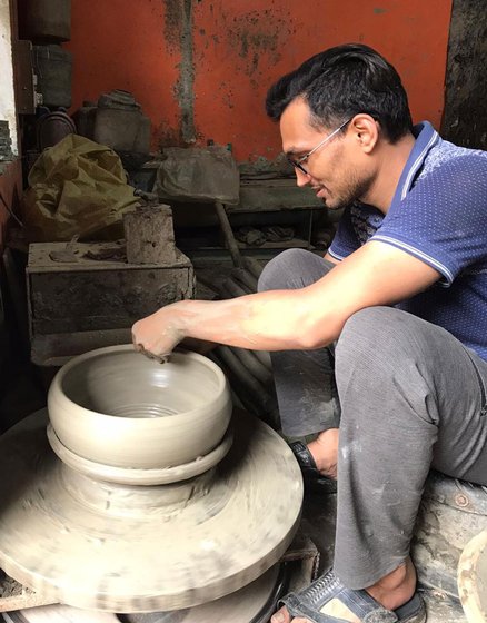 Narendra Prajapati (left): "...this virus has hit our work hard'. In Uttam Nagar, Ramrati and Rekha (right) have have been working on diyas but 'the joy is missing'

