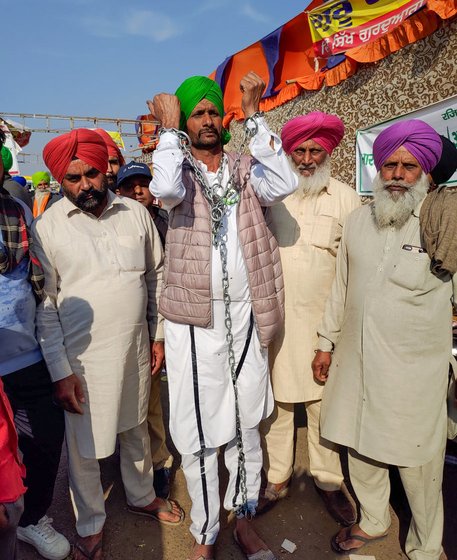 Holding the five-kilo chain throughout the day makes Kabal Singh go numb. But it's nothing compared to the farmers' pain, he says