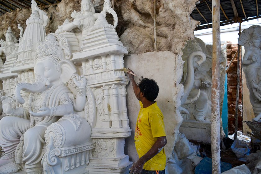 Shankar painting the bruised part after pasting the chinni mitti