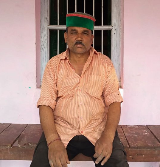 Joban Lal sitting outside his house.