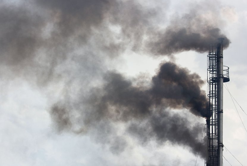 Left: New spots created for pyres at Nigam Bodh Ghat on the banks of the Yamuna in Delhi. Right: Smoke rising from chimneys of the CNG furnaces