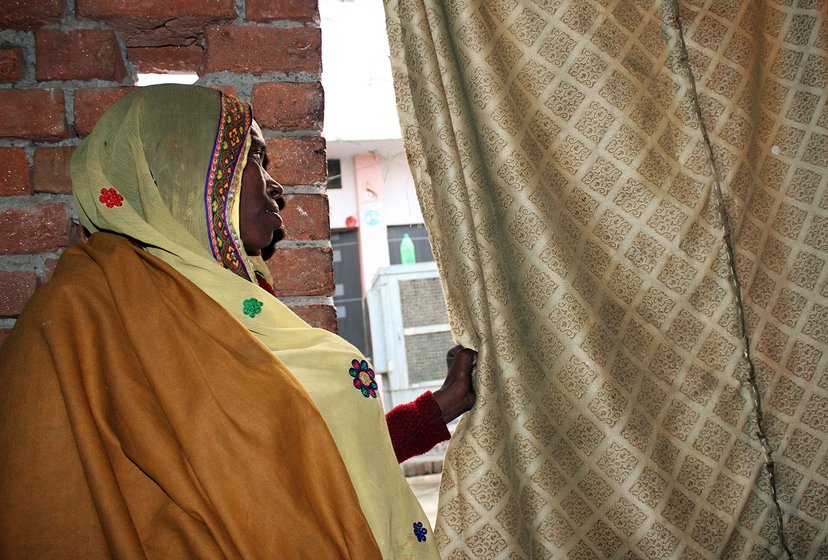 A woman looking outside her window