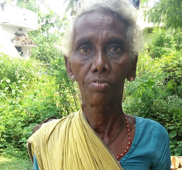 A woman showing her Aadhaar card