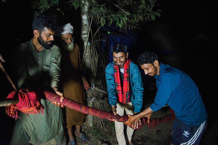 Bakarwal men (right) washing and drying the blankets.