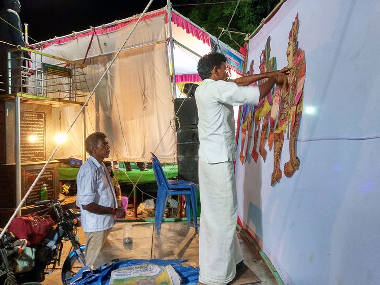 Rekhanara Kotilingam fixing puppets on the screen just before the performance