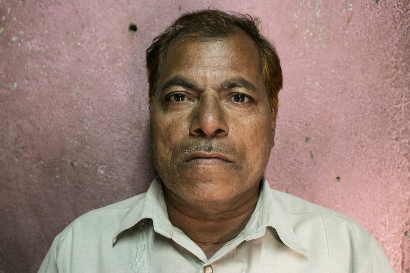 Portrait of a man standing in front of a wall