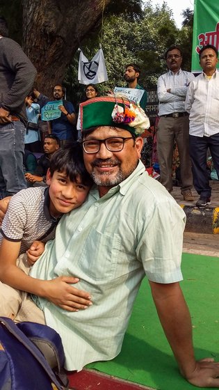 Prakash Bhandari of Palampur town in Kangra district with his eight-year-old son, Abir.