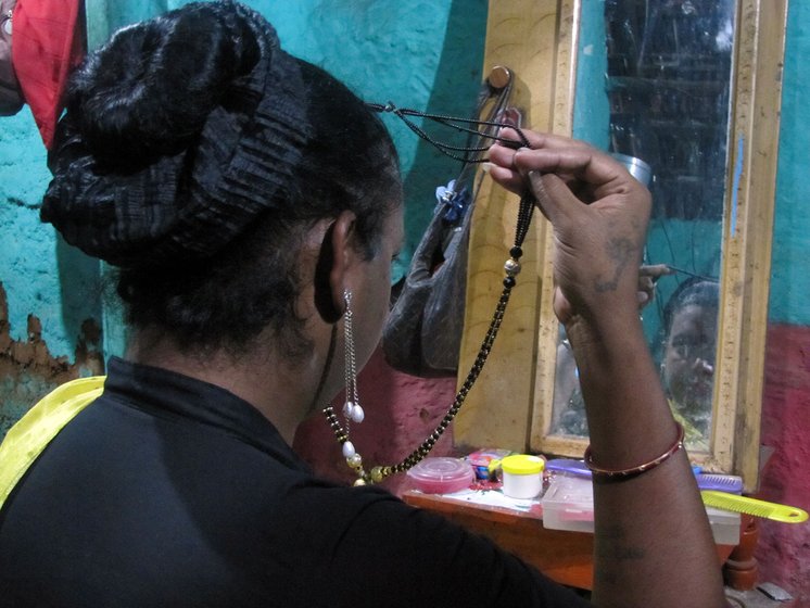 Radhika getting ready in a traditional saree and jewellery for her daily round of the markets to ask for money 