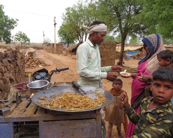 The motorcycle carries all the supplies and a small stove which is fired up to fry the noodles and vegetables. A couple of sauce bottles, onions, cabbage and the odd carrot are used