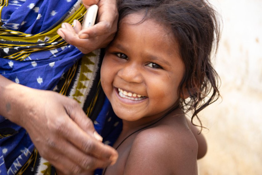 While being photographed, Janaki tries to hide behind her mother Namani