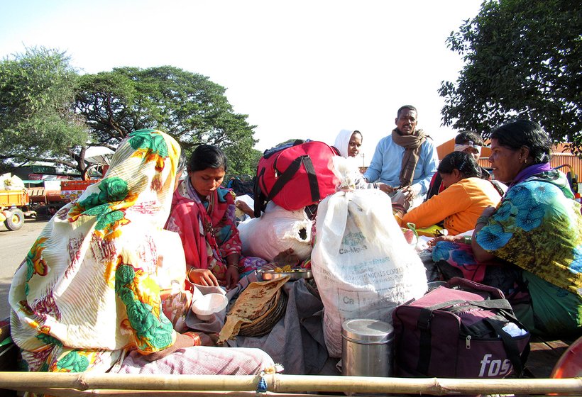 Migrants eating on the go in a trailer 