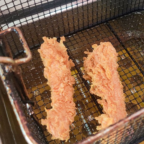 This KFC's fried chicken (left) and burgers (right) are popular dishes among Kulamora’s locals and tourists