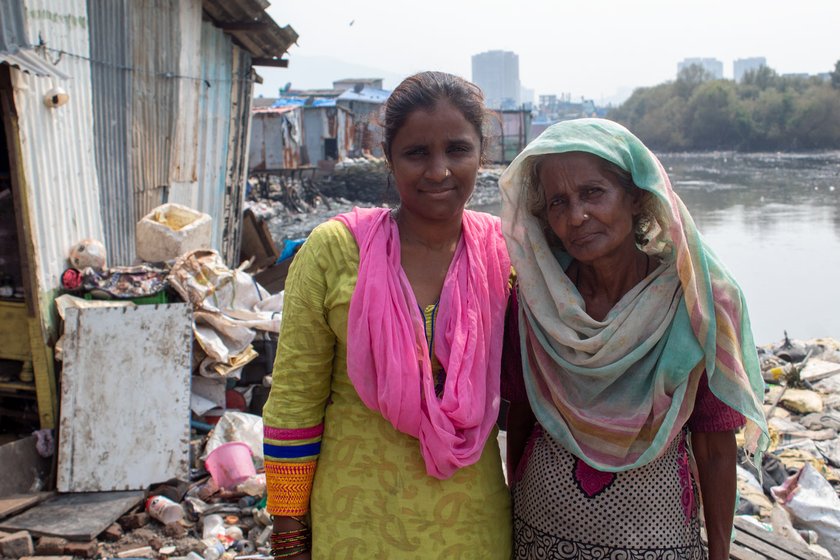 Kitabun with her daughter-in-law Zahida (left), who looks after the 11 children (right) of the family