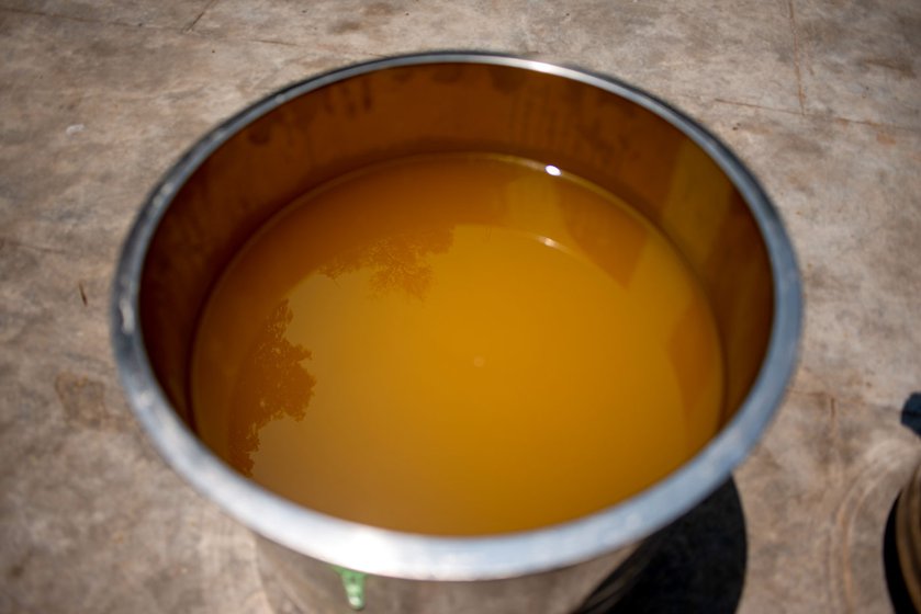 Freshly pressed sesame oil (left) sits in the sun until it clears. The de-oiled cake, ellu punaaku (right) is sold as feed for livestock