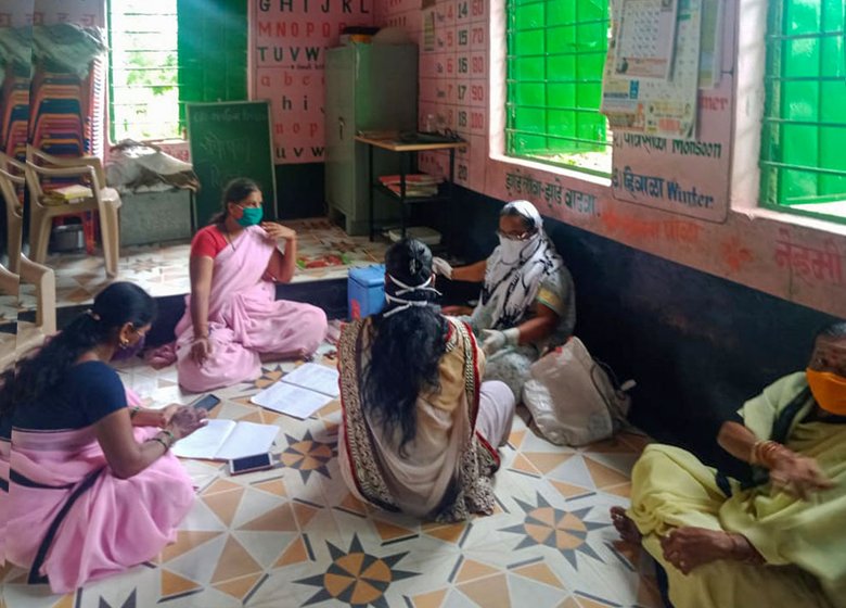 'Before April 6...I didn’t receive any no masks, gloves...' says Shakuntala Devi (standing third from left, and sitting with the green mask)