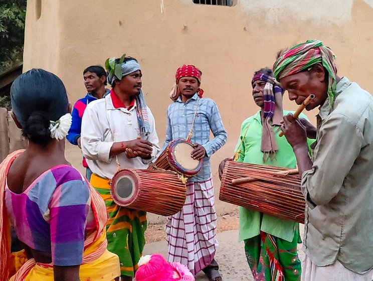 Members of the community dance and sing together (right)