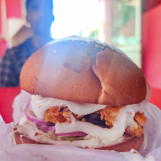 This KFC's fried chicken (left) and burgers (right) are popular dishes among Kulamora’s locals and tourists