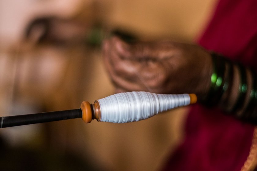 Before he retired, Vasant was one of the most skilled weavers in Kolhapur's Hatkanangle taluka. Vimal would wind the weft yarn on a charakha (right) for him to weave 

