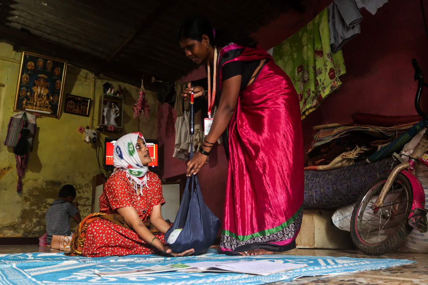 Shubhangi Kamble weighing a 22-day-old newborn in Kolhapur’s Arjunwad village