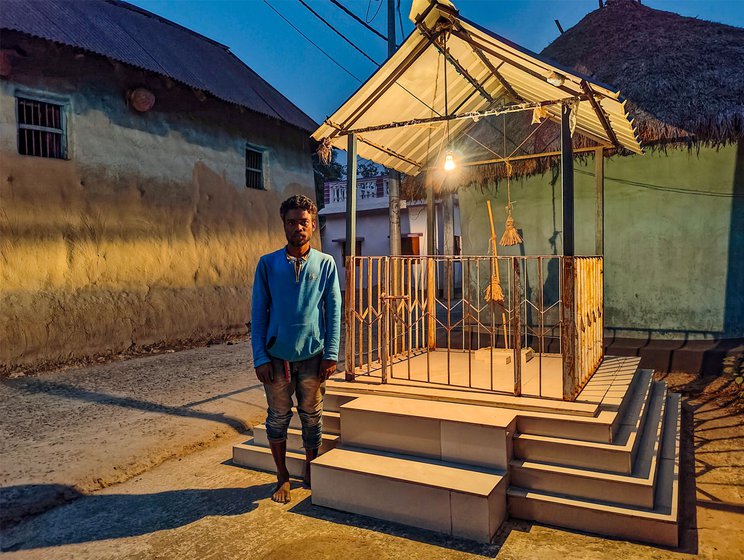 Right: Tapan in front of the sacred altar where all the deities are placed, found in the centre of the village