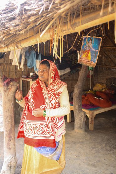 Right: Gyanmati's sister-in-law Chanda. Behind her, is the portrait of Ram hung prominently in front of the house