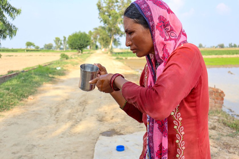 Rajveer drinking water to cool down. Working conditions in the hot summer months are hard and the labourers have to take breaks