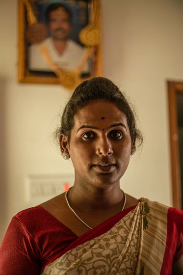 Left: Varsha at her home in Pudukkottai district. Behind her is a portrait of her deceased father P. Karuppaiah, a daily wage farm labourer. Right: Varsha dressed as goddess Kali, with her mother K. Chitra and younger brother K. Thurairaj, near the family's house in Viralimalai