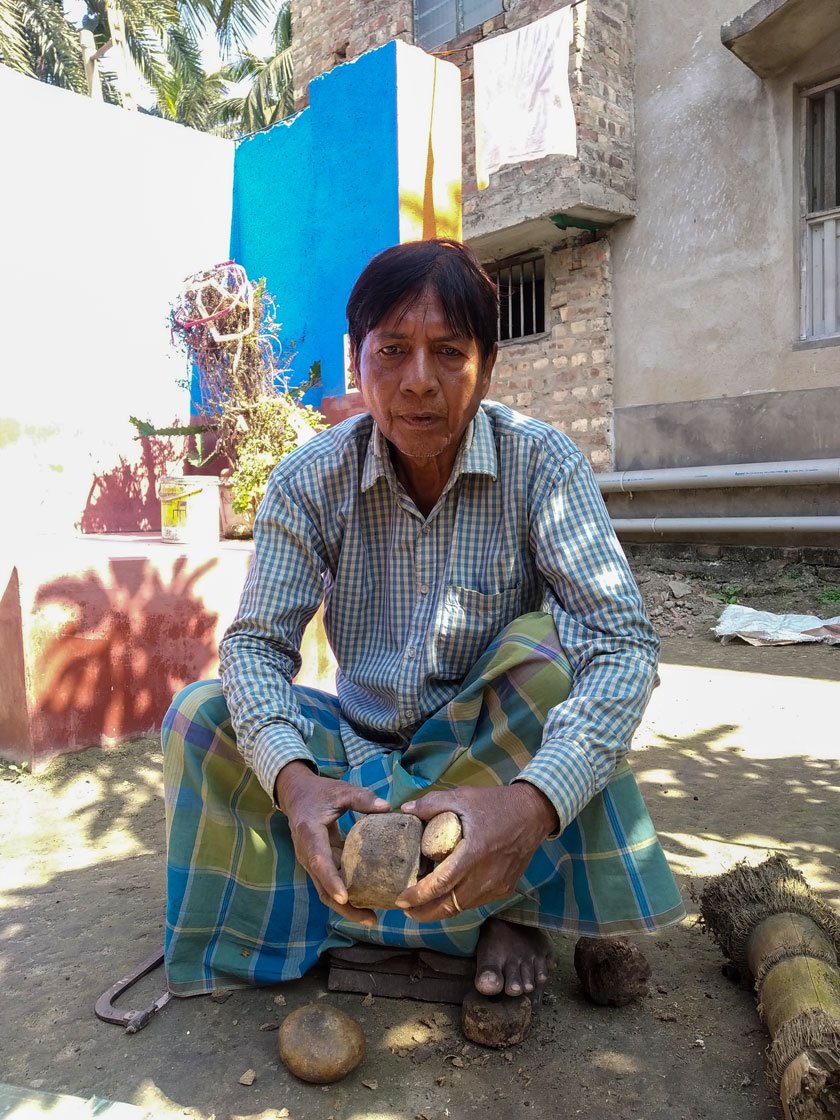 Left : Ranjit holds a cut rhizome and sits in position to undertake the task of chiselling.