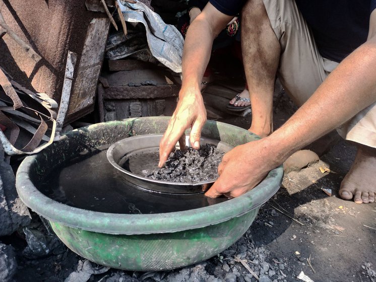 Rajesh removing small stones from the coal (left).