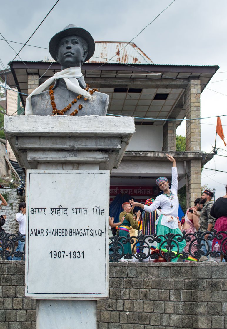 Right: A Bhagat Singh statue with participants of the rally in the background