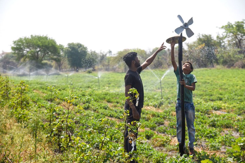 Ganesh Sarode and his friend demonstrate a small device they’ve built to make noise – a small rotator beats a steel plate through the day as a substitute to a scarecrow