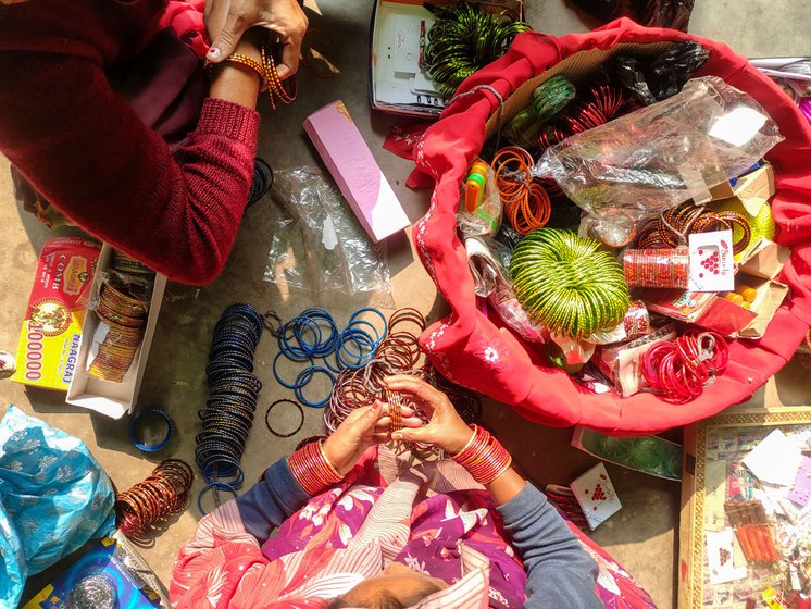 Left: The orchestra d ancers buy cosmetics and accessories from a woman who comes to their house in the outskirts of the city.