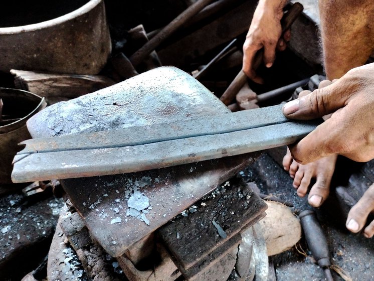 The raw metal (left) is hammered and shaped on the airan (metal block). It is periodically placed inside the forge for ease of shaping