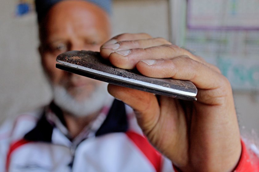 He checks if the edges of the wouch are now sharp enough to remove flaws from a delicate pashmina shawl