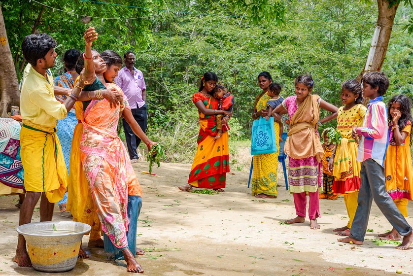 Left: At the beginning of the ceremonies during the theemithi thiruvizha , a few women from the spectators are overcome with emotions, believed to be possessed by the deity's sprit.