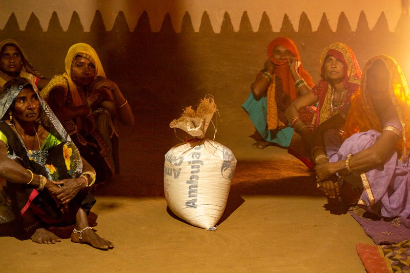 Galsing's sisters sit, grief-stricken, after having sung songs of mourning