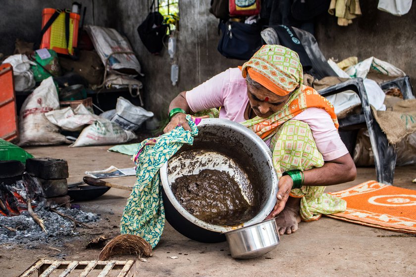 After stirring the castor seeds and water mixture for two hours, Narayan and Kusum separate the oil floating on top from the sediments