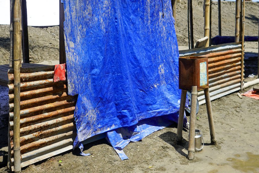 Right: A traditional sand-charcoal filter in front of his flood-ravaged house. Because of the high iron level, you cannot drink unfiltered water here