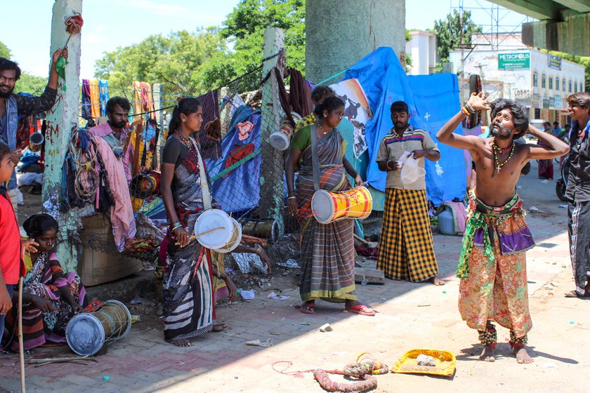 A group of people from the Chaatai or whip-lashing community performing in front of the Tirupparankundram Murugan temple in Madurai