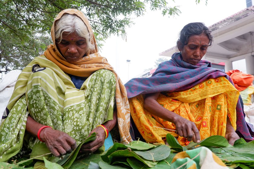 Outside Daltonganj station, Geeta spreads a blue polythene sheet on the ground and the two resume the task of crafting donas. The women also take orders for pattals or plates. Their 'shop' is open 24x7 but they move into the station at night for safety. They will stay here until all their wares are sold