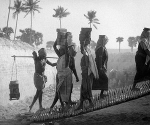 women carrying bricks