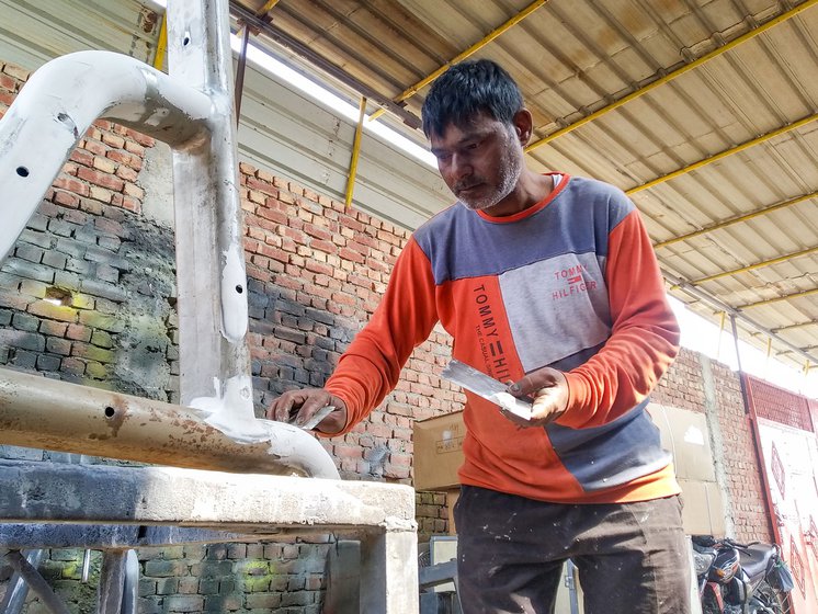 Left: Shakir Ansari applies body filler putty to cover gaps on the surface at the joints.