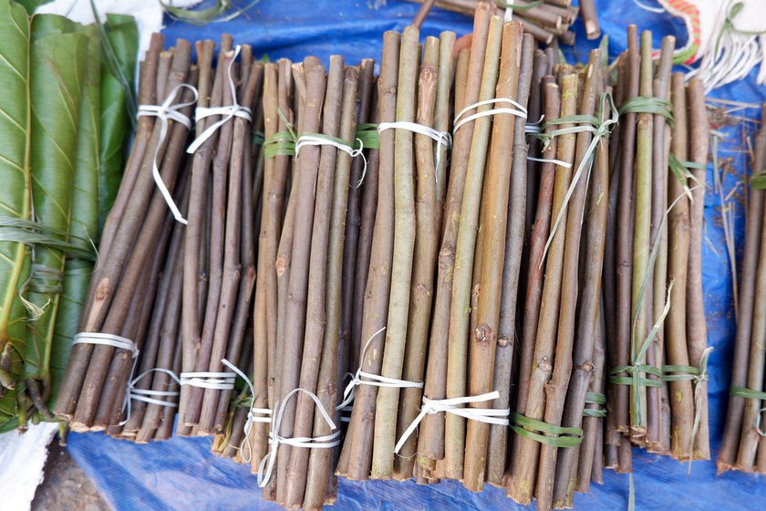 Right: Bundles of datwan are bought by passengers from the night train.