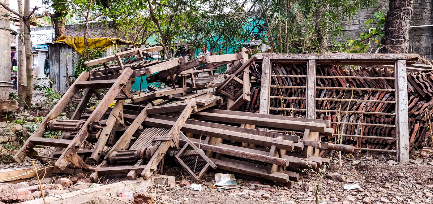 Old dobbies and other handloom parts owned by Babalal Momin, one of Rendal's last two weavers to still use handloom, now lie in ruins near his house