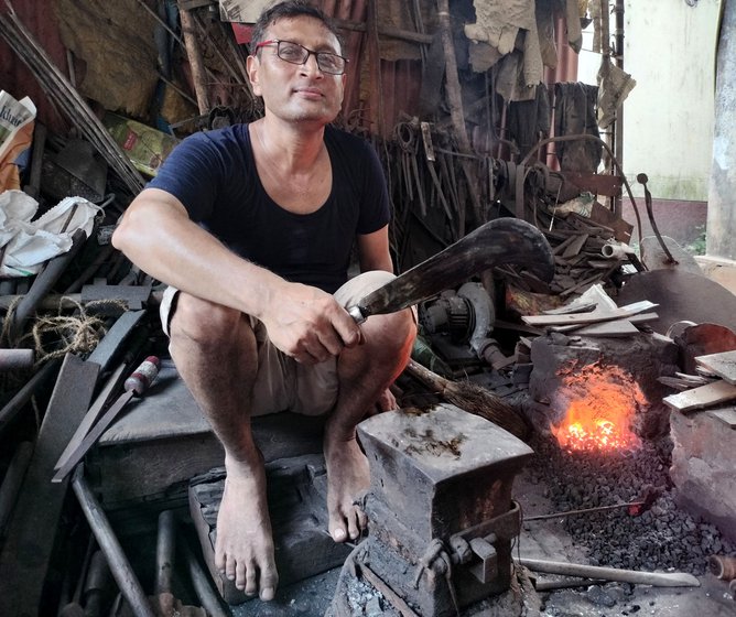 Right: Rajesh holding the finishing sickle made by him